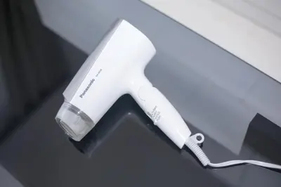 a white electric toothbrush sitting on top of a desk at NorthRiverSKY in Tokyo