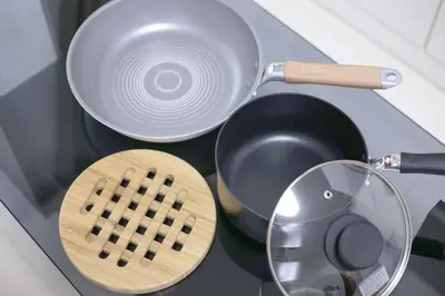 a stove top with a frying pan and a strainer at NorthRiverSKY in Tokyo
