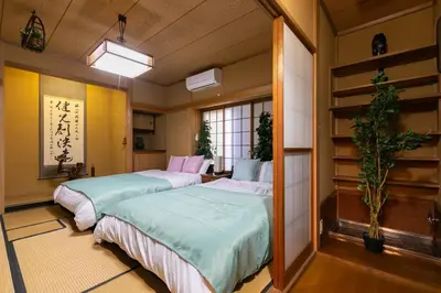 a room with two beds in a room at Shinjuku Japanese-style two storey house in Tokyo