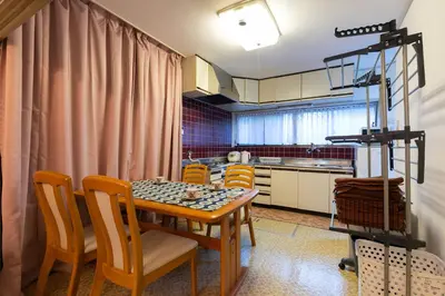 a kitchen with a dining room table and chairs at Shinjuku Japanese-style two storey house in Tokyo
