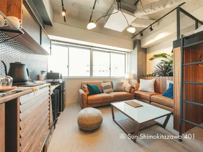a living room with a couch and a table at illi Sun Shimokitazawa in Tokyo