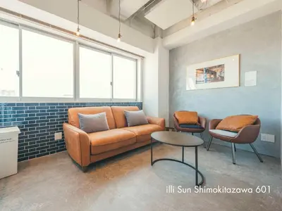 a living room with a couch and two chairs at illi Sun Shimokitazawa in Tokyo