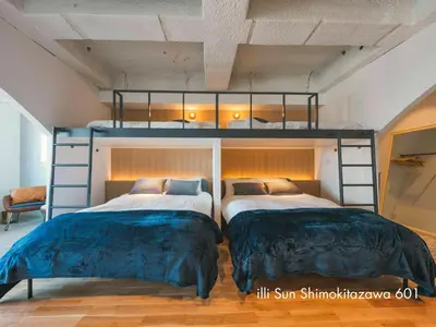 a bedroom with two bunk beds in it at illi Sun Shimokitazawa in Tokyo