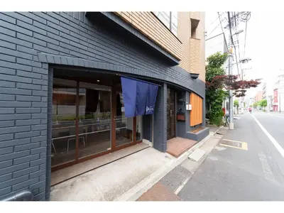 a store front with glass doors on a building at Oyado Kien Ryogoku in Tokyo