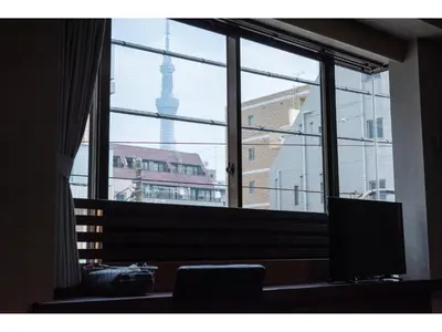 a room with a large window with a view of a city at Oyado Kien Ryogoku in Tokyo