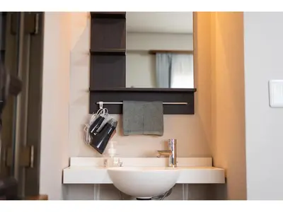 a bathroom with a sink and a mirror at Oyado Kien Ryogoku in Tokyo