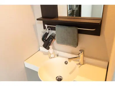 a bathroom with a white sink and a mirror at Oyado Kien Ryogoku in Tokyo