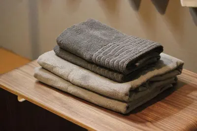 a pile of towels sitting on top of a table at Ikebukuro Apartment by Tranova in Tokyo