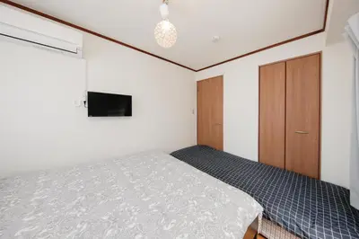 a small bedroom with a bed and a cabinet at Ikebukuro Apartment by Tranova in Tokyo