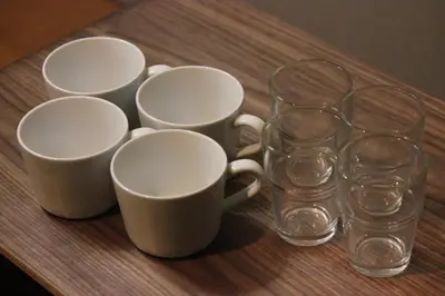 a group of cups and glasses on a wooden table at Ikebukuro Apartment by Tranova in Tokyo