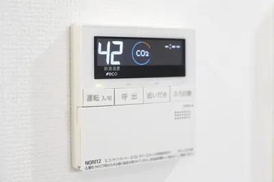 a digital clock on a wall with a thermometer at Real Kinshi in Tokyo