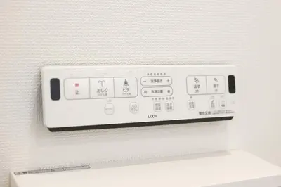 a white control panel on a white wall at Real Kinshi in Tokyo