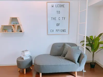 a living room with a chair and a picture on the wall at Dash Living Higashi Azabu in Tokyo