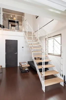 a white staircase in a white room with wooden floors at Dash Living Higashi Azabu in Tokyo