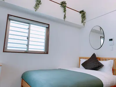 a bedroom with a bed and a window at Dash Living Higashi Azabu in Tokyo