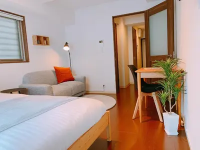a bedroom with a bed and a chair and a desk at Dash Living Higashi Azabu in Tokyo