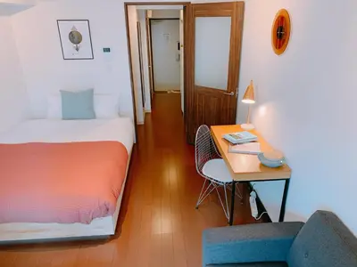 a bedroom with a bed and a desk and a chair at Dash Living Higashi Azabu in Tokyo