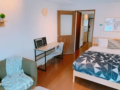 a bedroom with a bed and a desk with a computer at Dash Living Higashi Azabu in Tokyo