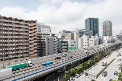 a bridge over a city with a train on it at Dash Living Higashi Azabu in Tokyo
