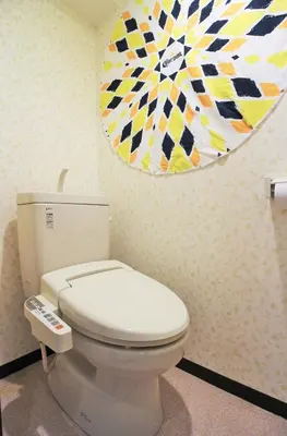 a bathroom with a toilet and a painting on the wall at Cozy room in Itabashi in Tokyo