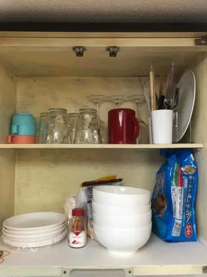 a shelf with dishes and other items in a refrigerator at Cozy room in Itabashi in Tokyo