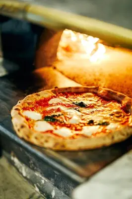 a pizza sitting on top of a table at NOHGA HOTEL AKIHABARA TOKYO in Tokyo