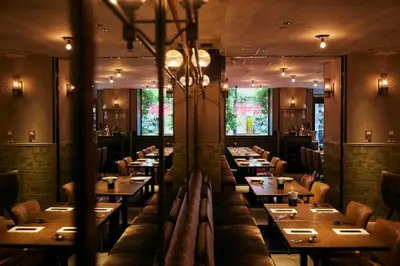 a dining room with wooden tables and chairs at NOHGA HOTEL AKIHABARA TOKYO in Tokyo