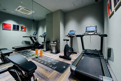 a gym with treadmills and machines in a room at NOHGA HOTEL AKIHABARA TOKYO in Tokyo