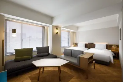 a hotel room with a bed and a couch at NOHGA HOTEL AKIHABARA TOKYO in Tokyo