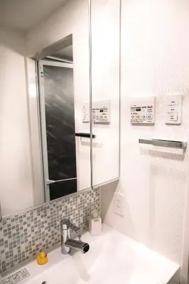 a bathroom with a sink and a mirror at Dash Living Nihonbashi in Tokyo