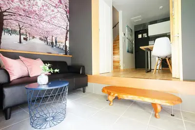 a living room with a couch and a table at SAKURANOMA in Tokyo