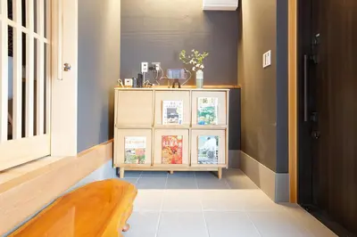 a hallway with a dresser with books on it at SAKURANOMA in Tokyo