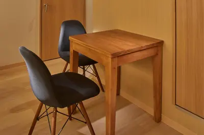 two chairs next to a wooden table and a desk at Stay SAKURA Tokyo Shinjuku Hyakukura in Tokyo