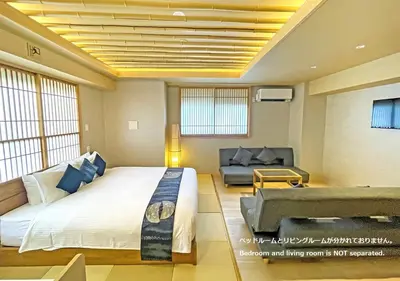 a bedroom with a large bed and a couch at Stay SAKURA Tokyo Shinjuku Hyakukura in Tokyo