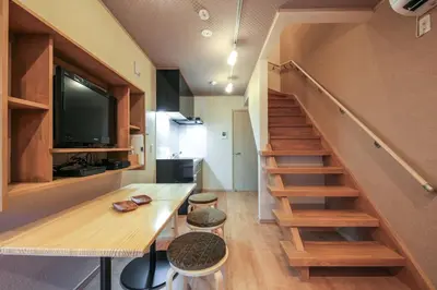 a small house with a staircase and a living room at YADOYA Iriyaan in Tokyo
