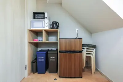 a small kitchen with a counter and a microwave at YADOYA Iriyaan in Tokyo