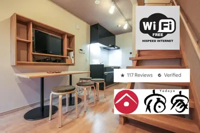 a room with a bar with stools and a tv at YADOYA Iriyaan in Tokyo