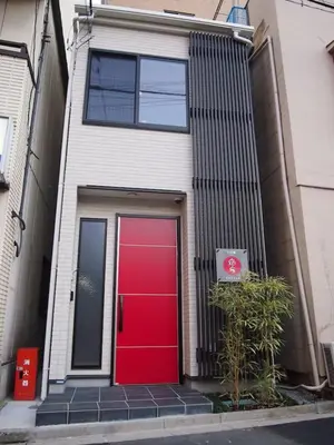 a red front door of a house with a red door at YADOYA Iriyaan in Tokyo