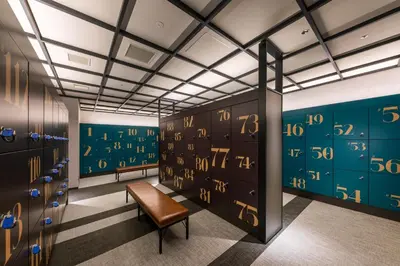 a locker room with lockers and a chair at Tokyo Bay Shiomi Prince Hotel in Tokyo