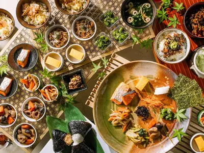 a table with a plate of food and bowls of food at Tokyo Bay Shiomi Prince Hotel in Tokyo