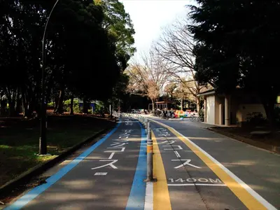 an empty street with blue and yellow lines on the road at COTO Tokyo Shibuya 7 in Tokyo