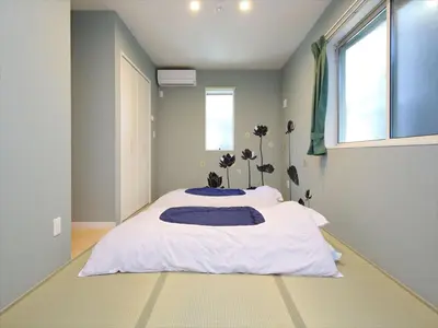 a bedroom with a large white bed with a window at COTO Tokyo Shibuya 7 in Tokyo