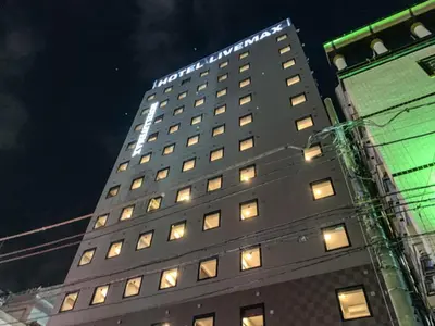 a tall building with lights on top of it at HOTEL LiVEMAX Shinjuku Kabukicho in Tokyo