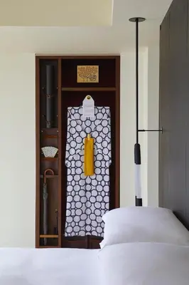 a room with a bed and a door with a window at Kimpton Shinjuku Tokyo by IHG in Tokyo