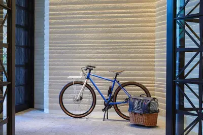 a blue bike parked next to a wall at Kimpton Shinjuku Tokyo by IHG in Tokyo