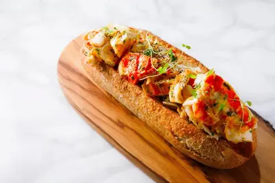 a sandwich sitting on a wooden cutting board at Kimpton Shinjuku Tokyo by IHG in Tokyo