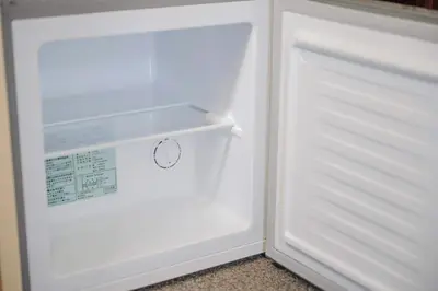 an empty white refrigerator with its door open at Allcomein Hotel Akihabara in Tokyo