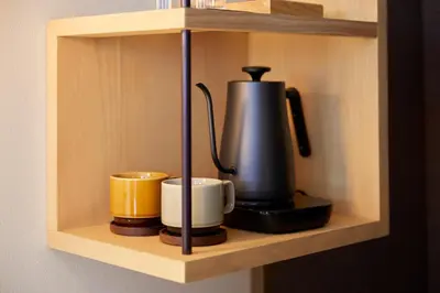 a coffee maker and two cups on a shelf at Agora Tokyo Ginza in Tokyo
