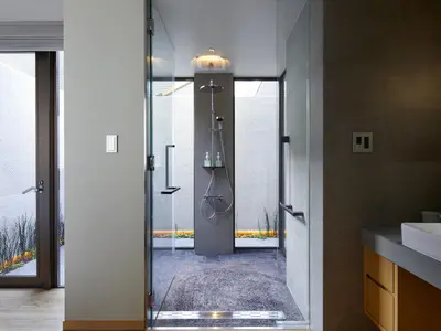 a bathroom with a shower with a glass door at Agora Tokyo Ginza in Tokyo