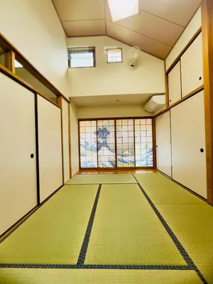 an empty room with a green floor and windows at Hao Bros. Home \u548c(WA) in Tokyo